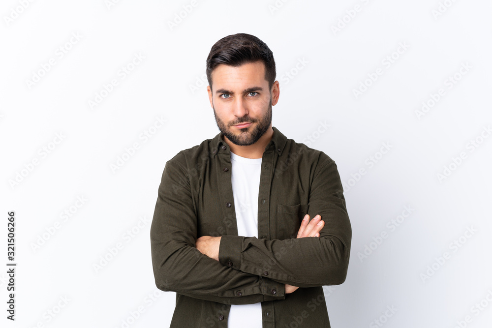 Young handsome man with beard over isolated white background feeling upset Young handsome man with beard over isolated white background feeling upset