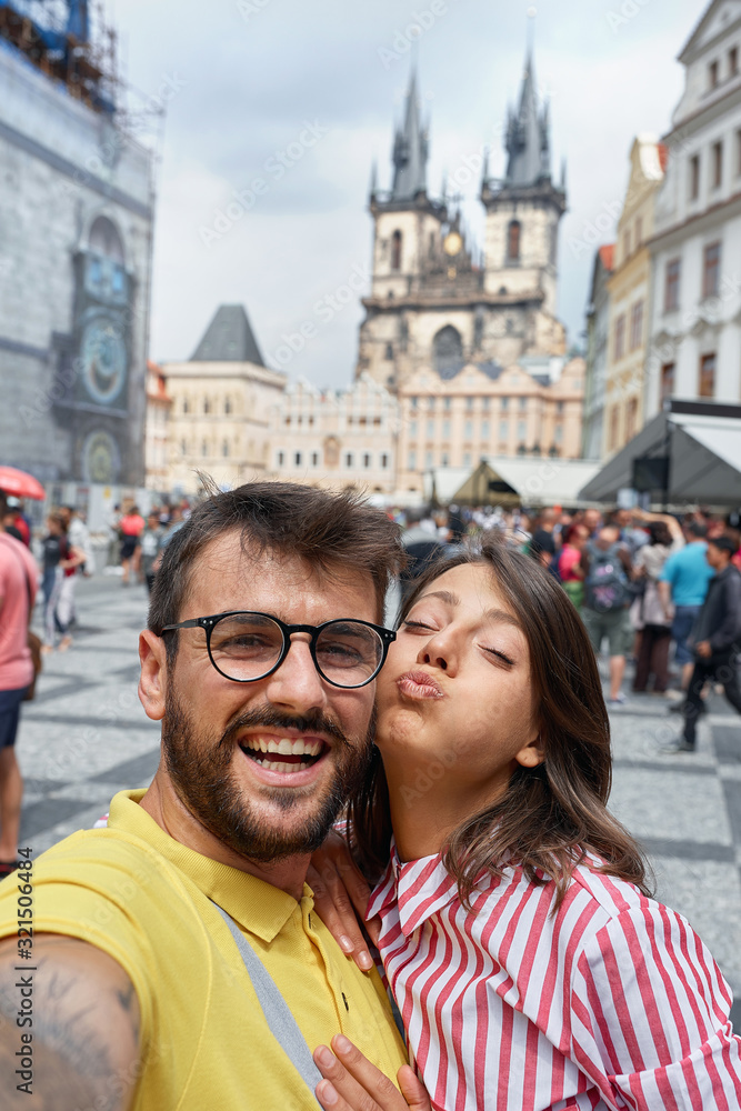 Man and woman walking in city streets on vacation tourism and making selfie.