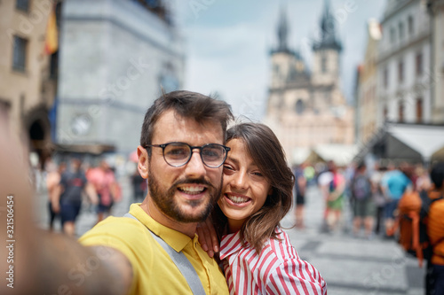 Couple in a vacation trip in city streets at Prague  on vacation making selfie.. © luckybusiness