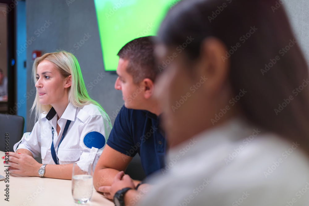 Security guard monitoring modern CCTV cameras in a surveillance room. Group of security guards sitting and monitoring. Security guard monitoring modern CCTV cameras in a surveillance room. Group of security guards sitting and monitoring.