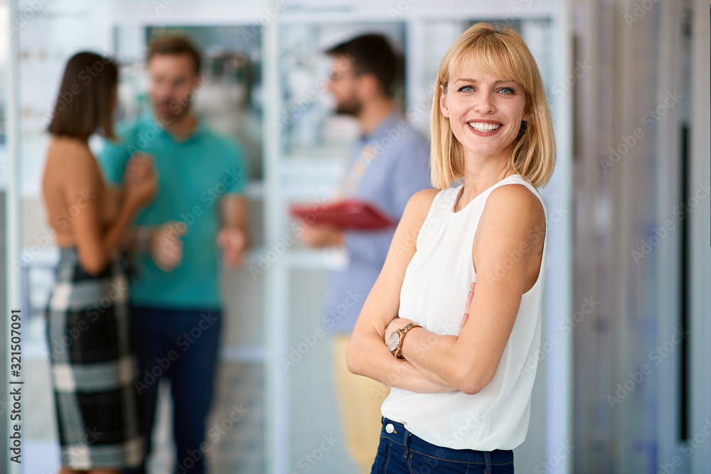 young confident handsome blonde female watching at camera with her arms crossed in casual outfit young confident handsome blonde female watching at camera with her arms crossed in casual outfit