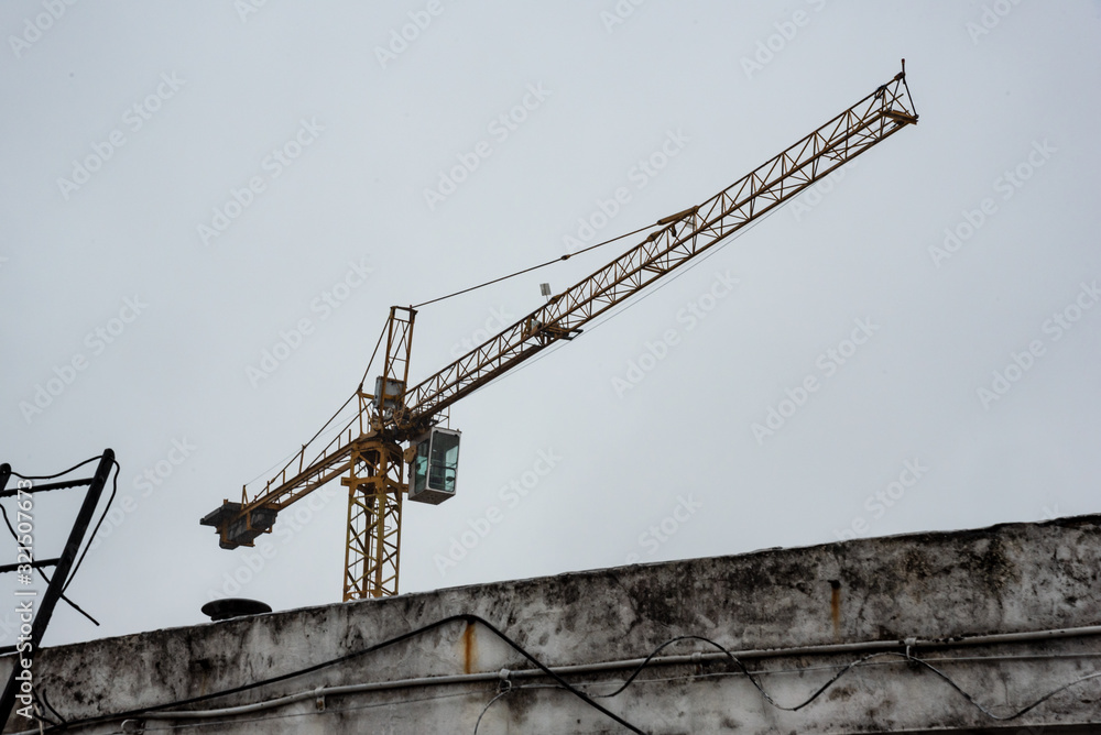 Isolated empty construction crane on a cloudy and rainy day