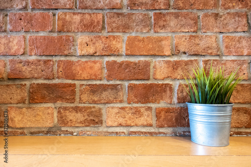 Wallpaper Mural Plant in metal pot on wooden table  front of red brick wall background in coffee shop. Copy space for text or designed. Torontodigital.ca