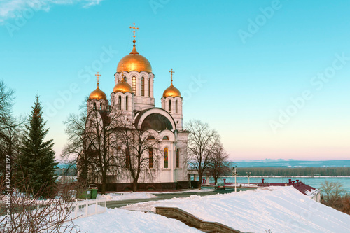 The Russian Church over the river on the background of blue sky © liper06