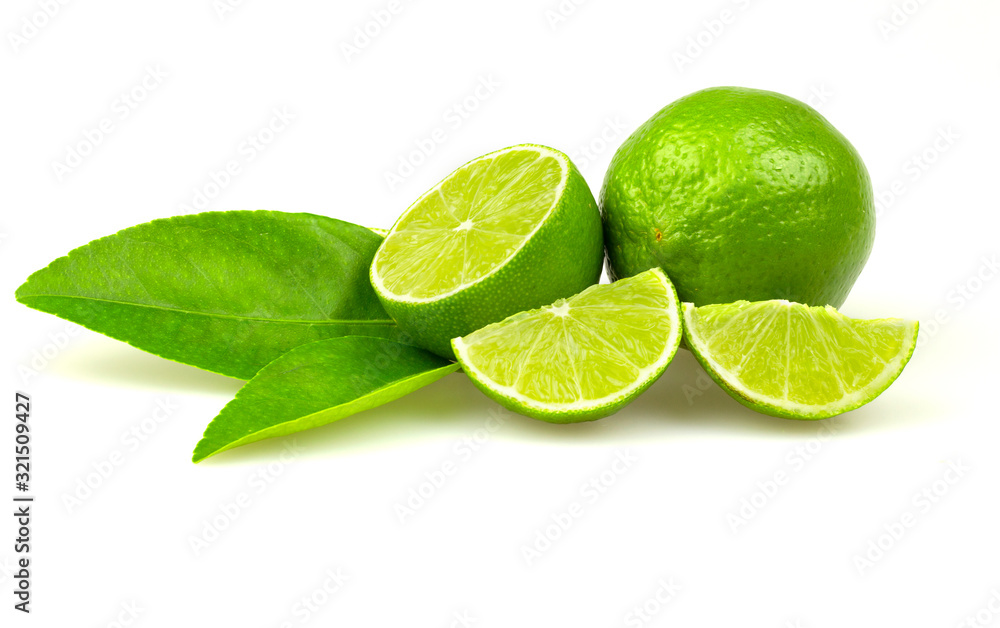 Lime is a natural green lime that is cut in half and thin, green leaves on a white background.