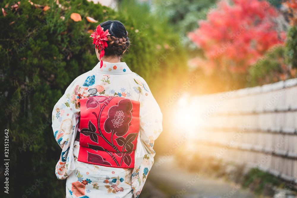 Young women wearing traditional Japanese Kimono with colorful maple trees in autumn is famous in autumn color leaves and cherry blossom in spring, Kyoto, Japan. Young women wearing traditional Japanese Kimono with colorful maple trees in autumn is famous in autumn color leaves and cherry blossom in spring, Kyoto, Japan.