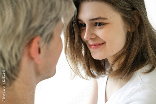 a beautiful European girl smiles and looks at her boyfriend. She likes talking.