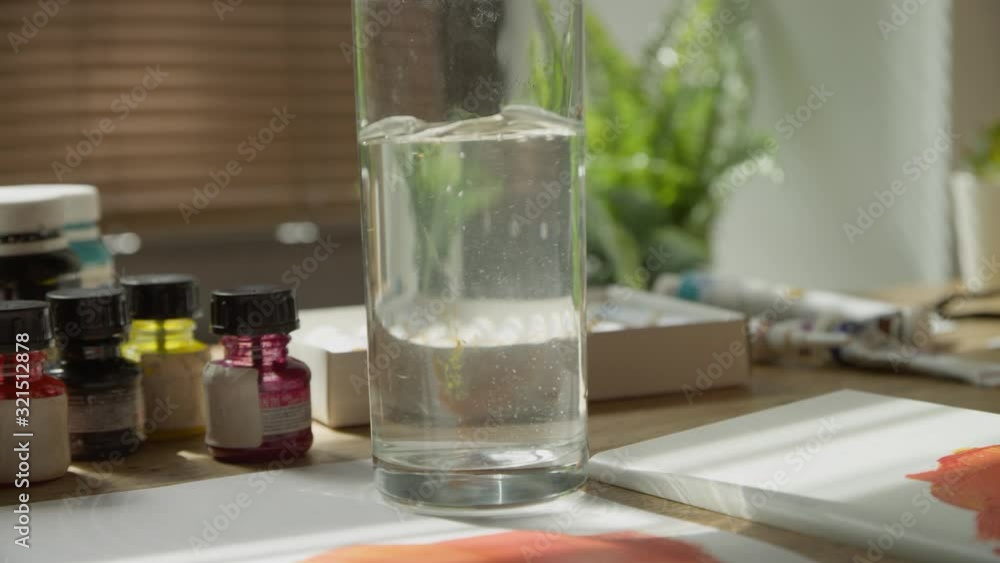 Close-up of the artist's Brush is moistened and rotated in a transparent glass with water. Washing and cleaning an art brush in a glass. Art workshop. Slow motion, 4K, Red Epic Close-up of the artist's Brush is moistened and rotated in a transparent glass with water. Washing and cleaning an art brush in a glass. Art workshop. Slow motion, 4K, Red Epic