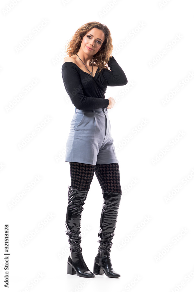 Side view of beautiful curly hair charming brunette having happy thoughts looking away. Full body length isolated on white background. Side view of beautiful curly hair charming brunette having happy thoughts looking away. Full body length isolated on white background.