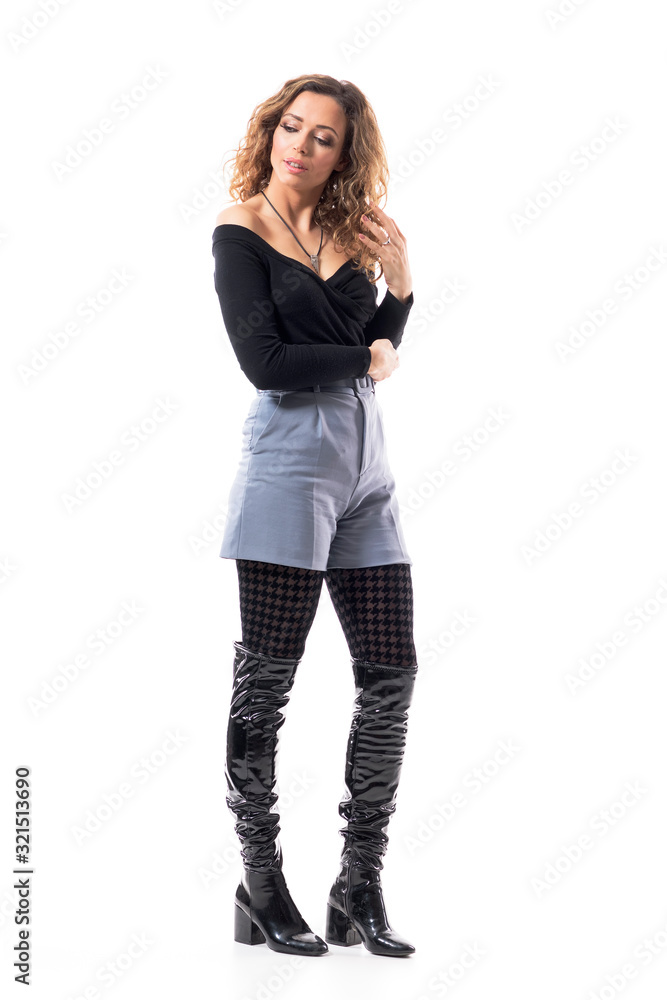 Sad pensive young beautiful woman in stylish outfit looking down and thinking with hand in hair. Full body length isolated on white background. Sad pensive young beautiful woman in stylish outfit looking down and thinking with hand in hair. Full body length isolated on white background.