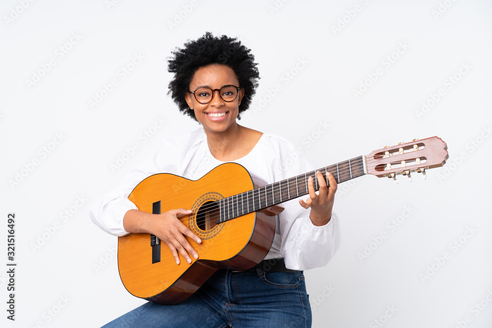 African american woman with guitar over isolated background smiling a lot African american woman with guitar over isolated background smiling a lot