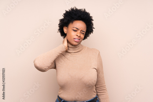 African american woman over isolated background with neckache