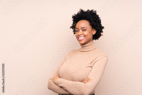 African american woman over isolated background with arms crossed and looking forward