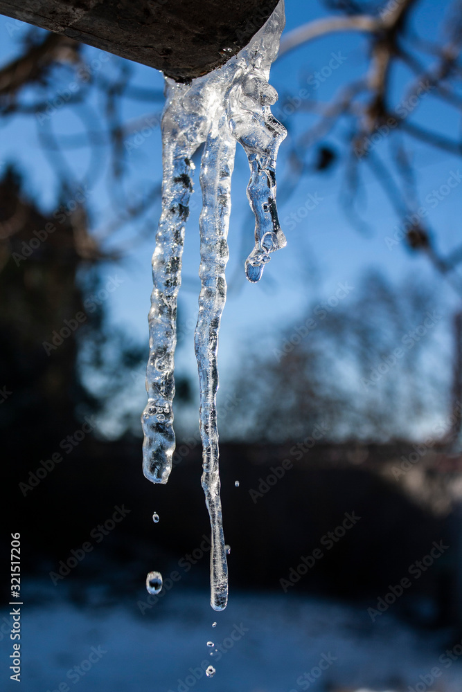 drops of water flow from an icicle drops of water flow from an icicle
