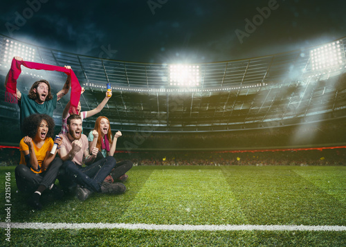 Soccer fans in the middle of the action during a night game at the stadium