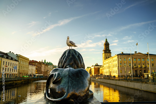 Sunset view from Burunnsparken city centre of Gothenburg. Lion Statue with seagull