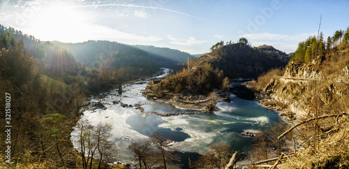 Fototapeta Naklejka Na Ścianę i Meble -  Panorama U turn in River, Half of Arda RIver is frozen in cold winter in Rodophi mountain in Bulgaria