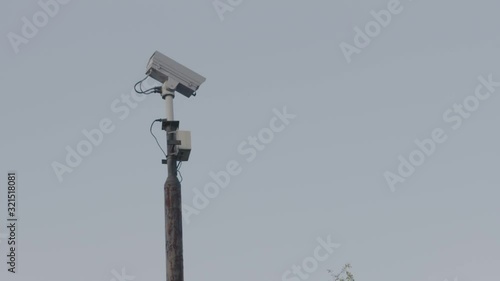 Downward pan to the entrance of building where person is walking away from window