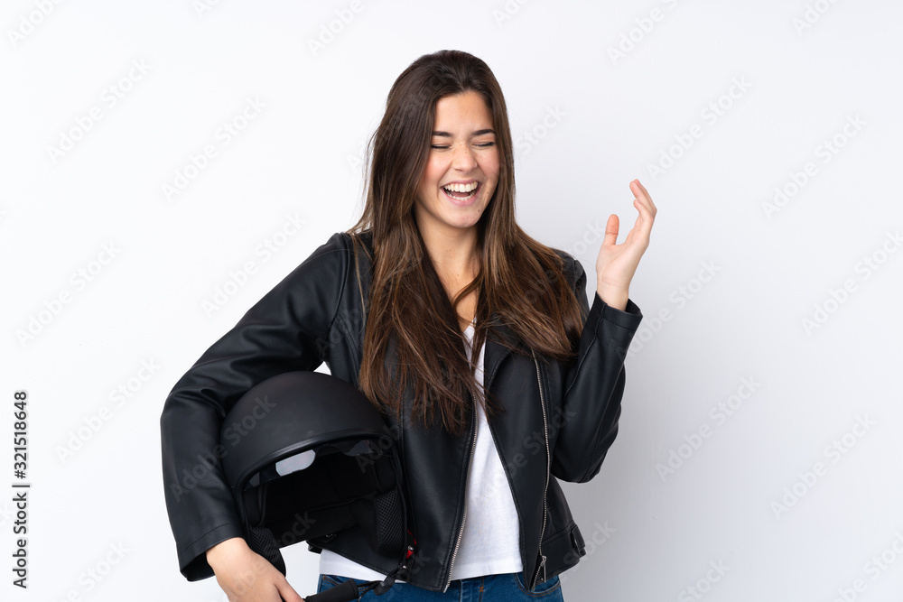 Young woman with a motorcycle helmet over isolated white background laughing Young woman with a motorcycle helmet over isolated white background laughing