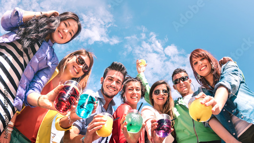 Friends group drinking fancy cocktails at summer beach party - Young millennial people having fun on luxury vacation at happy hour time - Travel lifestyle concept with milenials on bright vivid filter