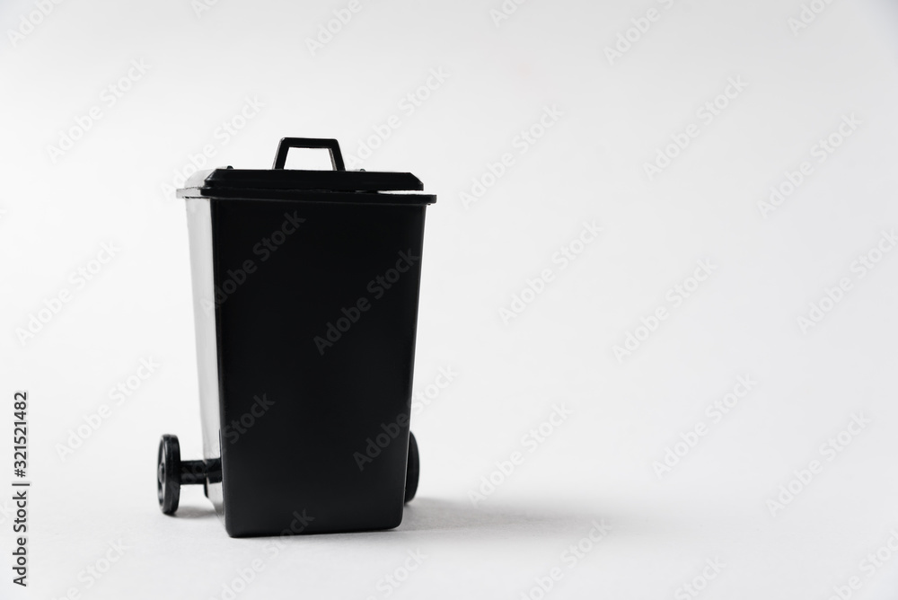 Black trash can on white background. Garbage tank. Copy space Stock Photo | Adobe Stock
