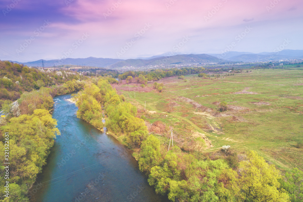 Panoramic view of the river in a mountain valley in early spring. View from above