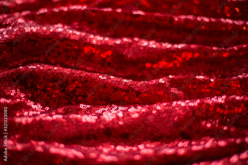 red background of shiny pleated fabric with blurred pleats red background of shiny pleated fabric with blurred pleats