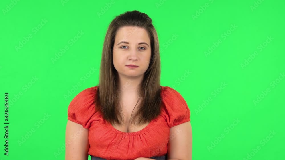 Portrait of girl talking about something then making a hush gesture, secret. Green screen Portrait of girl talking about something then making a hush gesture, secret. Green screen