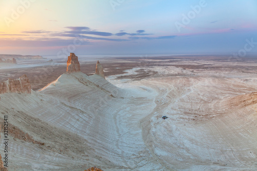 The Ustyurt Plateau. District of Boszhir. A group of tourists in cars stopped for the night. The bottom of a dry ocean Tethys. Rocky remnants. Kazakhstan. long shutter speed