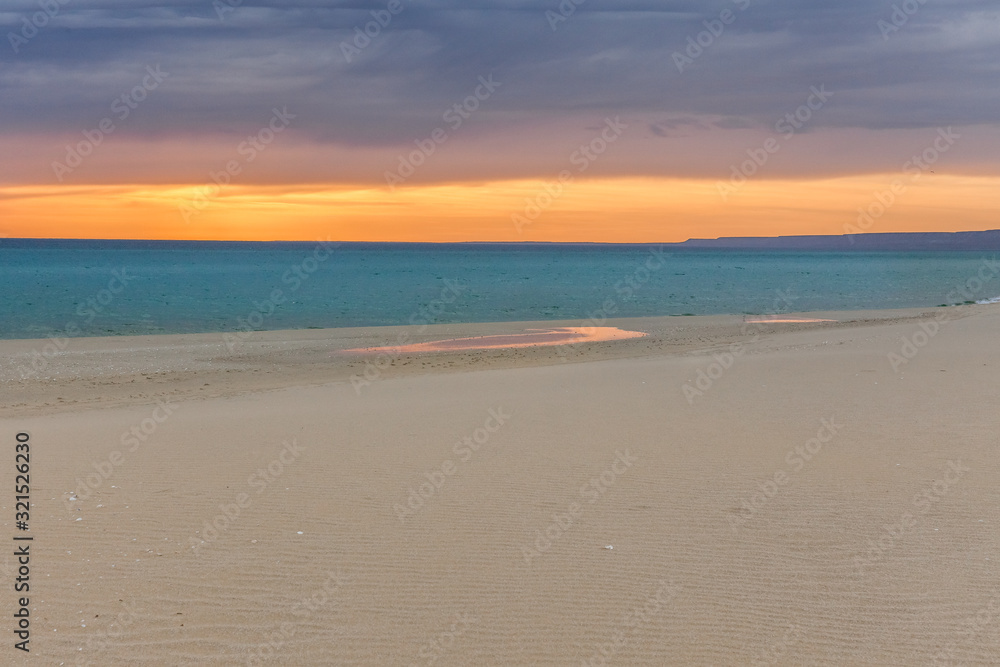Stormy sunset over the Caspian sea coast. background of a beautiful orange-red sunset on the Caspian sea . selective focus Stormy sunset over the Caspian sea coast. background of a beautiful orange-red sunset on the Caspian sea . selective focus