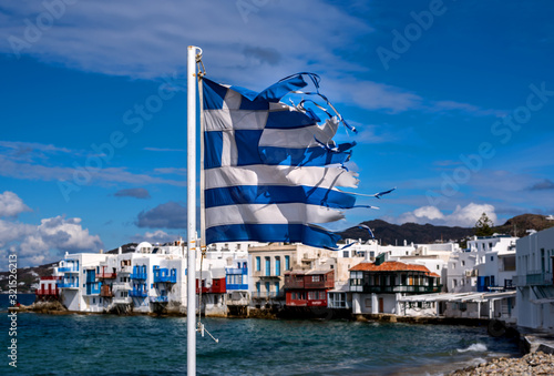 Greek flag waving in Little Venice in Mykonos, Greece