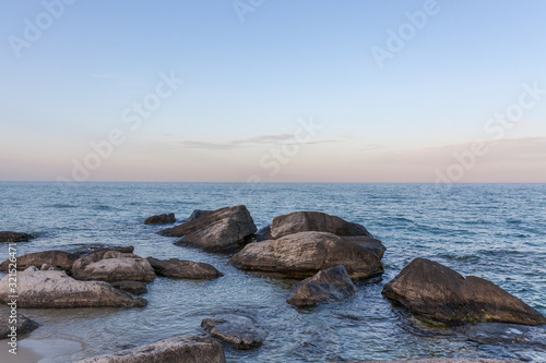 View of blue sea waves at rocky beach. Horizon line. Caspian Sea, sandstone coast. ustyurt. Selective focus, long shutter speed