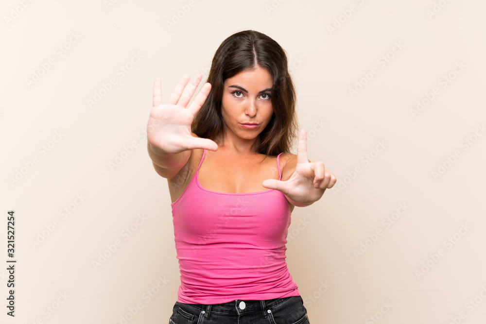 Young woman over isolated white background counting seven with fingers Young woman over isolated white background counting seven with fingers