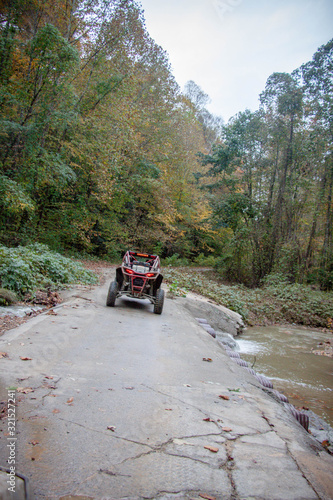 Sxs crossing small river on trail