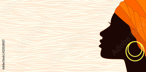 Silhouette of a young african woman.Girl with a turban and an earring. The face of a young African girl in profile on an abstract background 