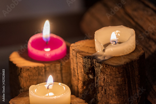  burning candles with ornate wood photo