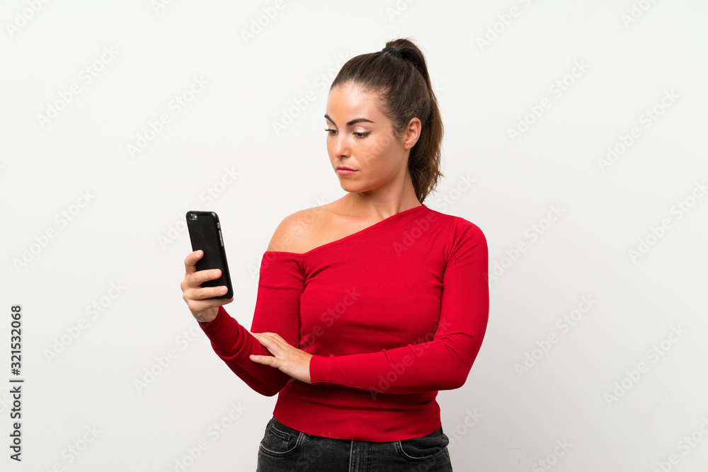 Young woman using mobile phone with sad expression Young woman using mobile phone with sad expression