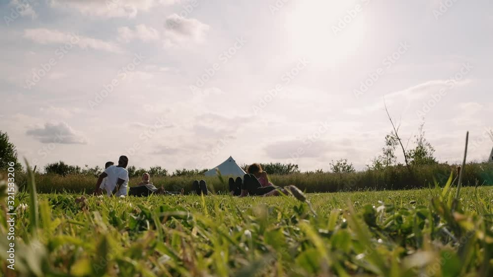 Group Of Mature Men And Women Lying On Grass Relaxing At The End Of Outdoor Yoga Class Group Of Mature Men And Women Lying On Grass Relaxing At The End Of Outdoor Yoga Class