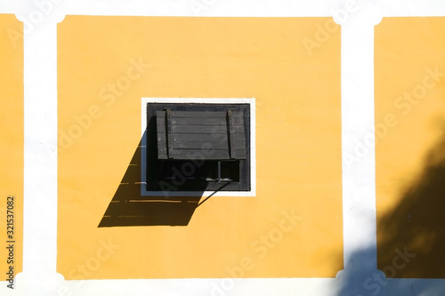 Wooden windows and yellow wall of a historic building in Zapresic, Croatia. photo