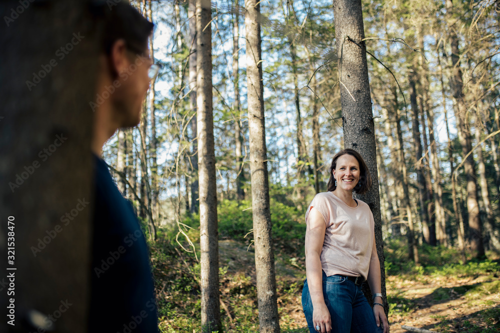 Smiling woman looking at man in a forest Smiling woman looking at man in a forest