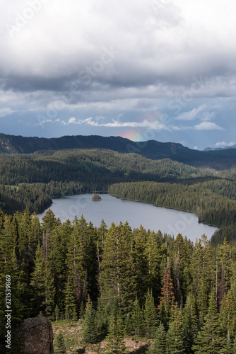 View Point on Grand Mesa National Forest Colorado has over 300 lakes. Partial Rainbow above Island Lake, which is one of the more popular destinations on the Grand Mesa.