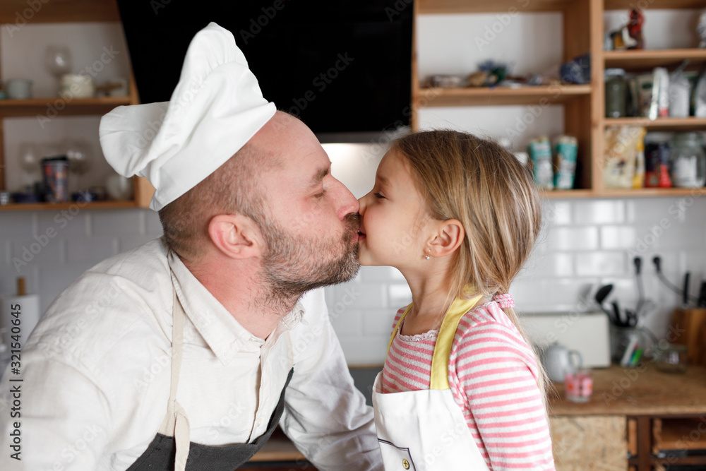 Father and daughter cooking in the kitchen Father and daughter cooking in the kitchen