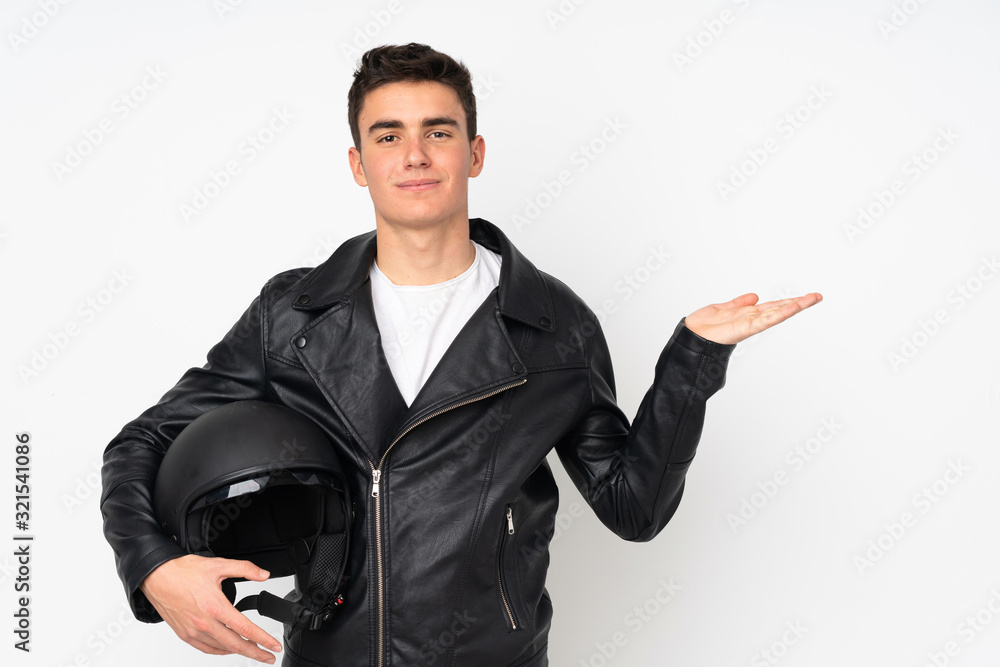 Man holding a motorcycle helmet isolated on white background holding copyspace imaginary on the palm Man holding a motorcycle helmet isolated on white background holding copyspace imaginary on the palm
