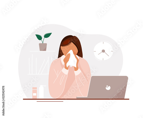 Young woman with flu in office blowing her nose
