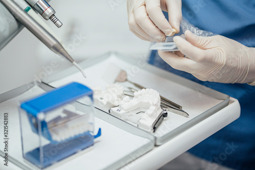 Close-up of dentist working on dentures photo