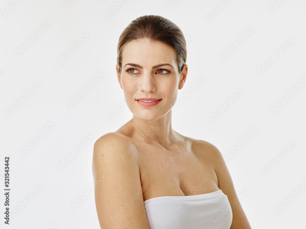 Portrait of smiling woman white background looking at distance Portrait of smiling woman white background looking at distance