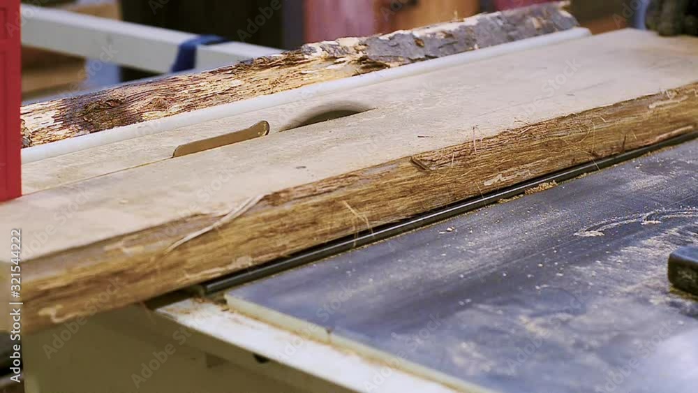 Cutting boards on a circular saw in carpentry workshop Cutting boards on a circular saw in carpentry workshop