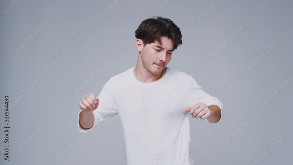 Wide Angle Studio Shot Of Young Man Against White Background Dancing In Slow Motion Wide Angle Studio Shot Of Young Man Against White Background Dancing In Slow Motion