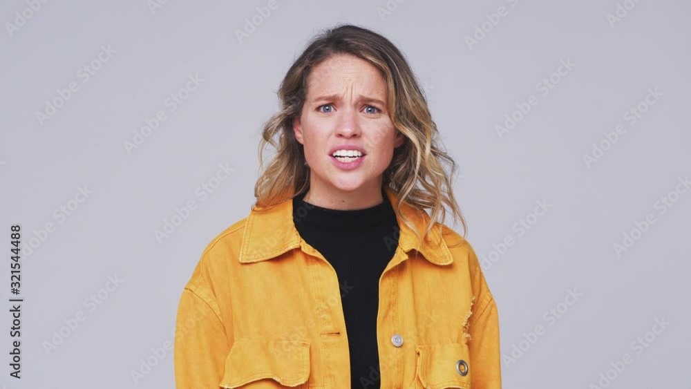 Wide Angle Studio Shot Of Angry Woman Shouting At Camera In Slow Motion Wide Angle Studio Shot Of Angry Woman Shouting At Camera In Slow Motion