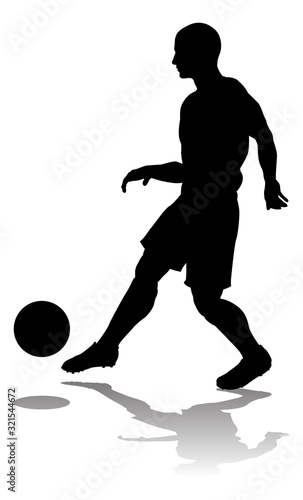 A soccer or football player in silhouette